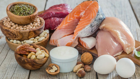 Protein heavy foods including salmon, chicken, eggs, beans, nuts, and steak - Kaizen Naturals