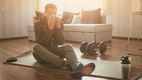 Man blowing his nose while trying to exercise - Kaizen Naturals