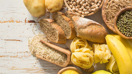 Selection of carb-heavy foods including bread, rice, pears, bananas, pastas, and grains - Kaizen Naturals